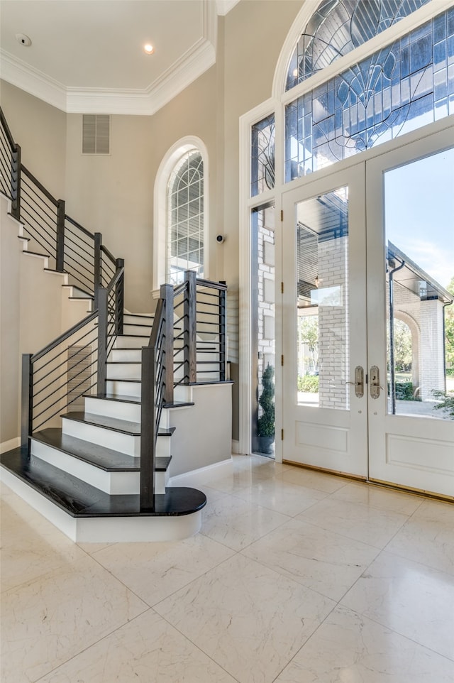 foyer featuring ornamental molding and french doors