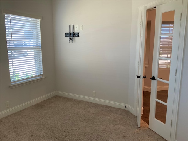 carpeted empty room with french doors