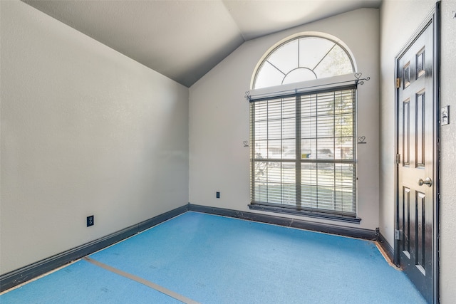 spare room with vaulted ceiling