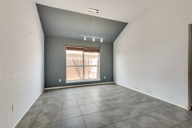 spare room with vaulted ceiling