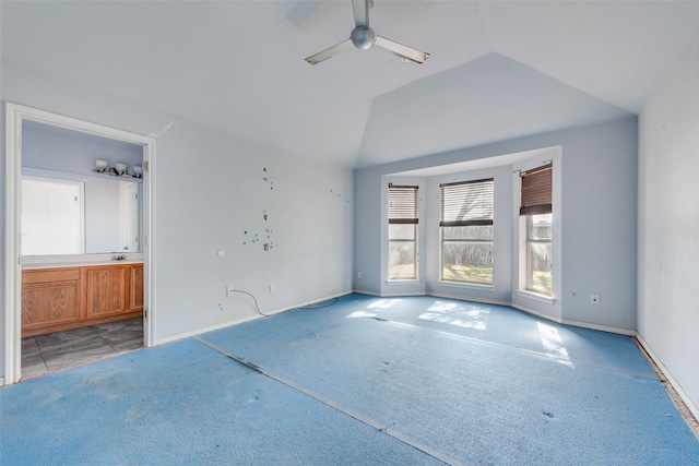 spare room with ceiling fan, lofted ceiling, and light carpet