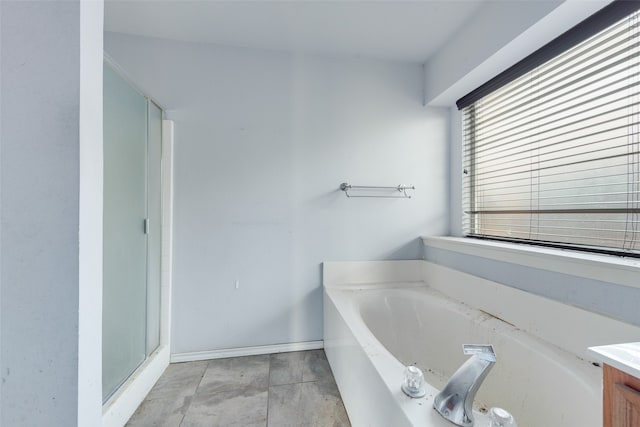 bathroom with vanity and independent shower and bath