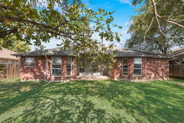 rear view of house with a yard