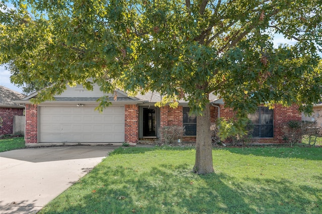 view of property hidden behind natural elements featuring a garage and a front yard