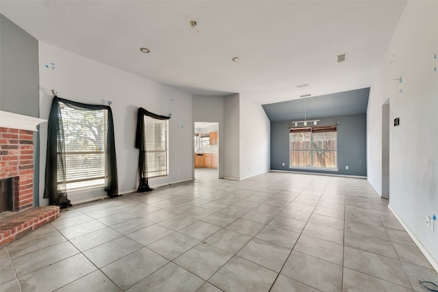 unfurnished living room featuring a fireplace and light tile patterned floors