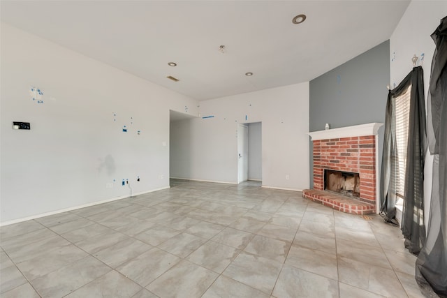 unfurnished living room with light tile patterned floors and a brick fireplace