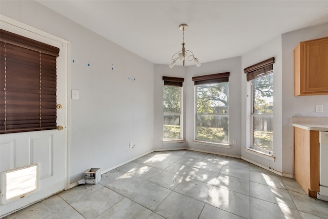 unfurnished dining area with light tile patterned flooring and an inviting chandelier