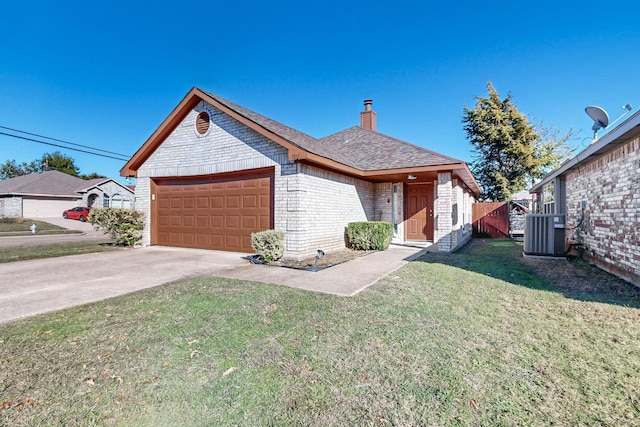 view of front of house featuring a garage, a front yard, and central AC