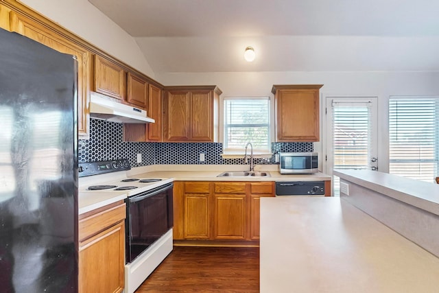 kitchen featuring lofted ceiling, dark wood-type flooring, black fridge, white electric range, and sink