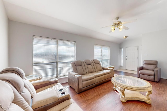 living room featuring ceiling fan, wood-type flooring, and vaulted ceiling