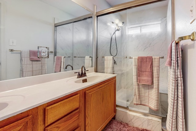 bathroom with vanity and a shower with shower door