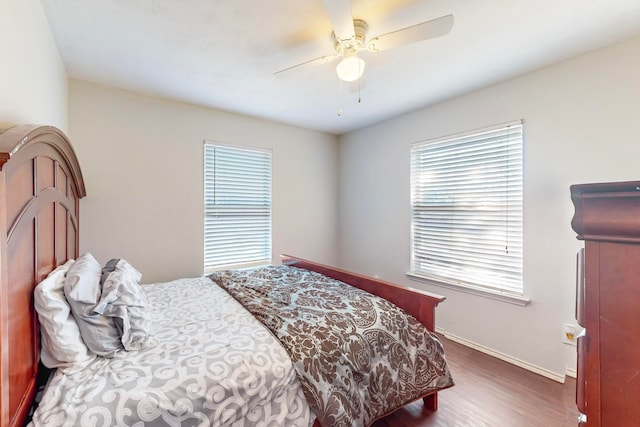 bedroom with ceiling fan and dark hardwood / wood-style floors