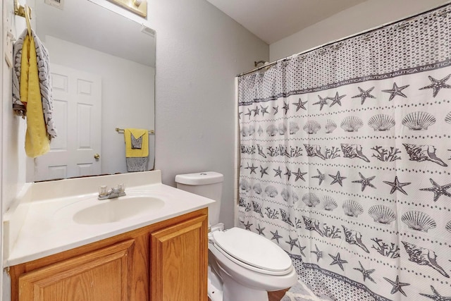 bathroom with a shower with curtain, vanity, and toilet