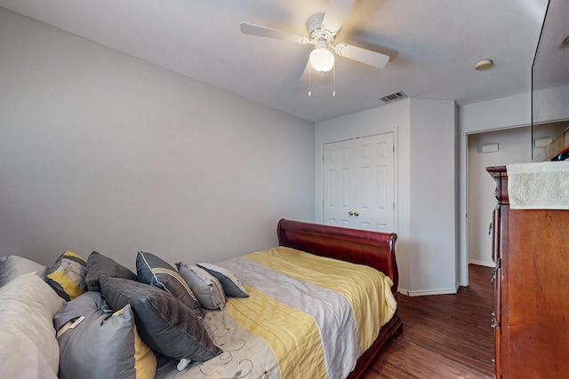 bedroom with ceiling fan, dark hardwood / wood-style flooring, and a closet