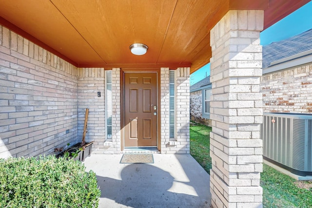 property entrance featuring central AC unit