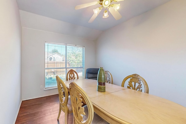 dining area with dark hardwood / wood-style floors, vaulted ceiling, and ceiling fan