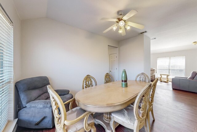 dining space featuring hardwood / wood-style floors, ceiling fan, and lofted ceiling