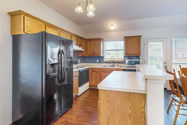 kitchen featuring black fridge, white electric range oven, vaulted ceiling, sink, and pendant lighting