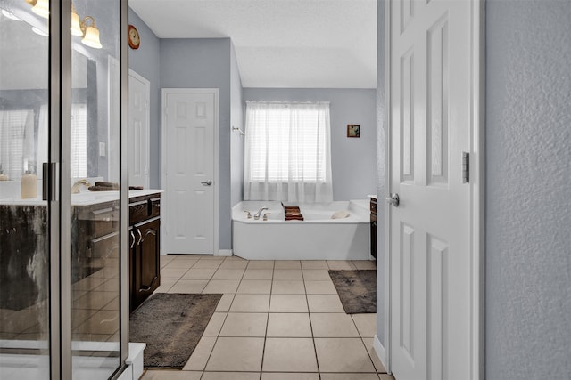 bathroom featuring tile patterned flooring, a textured ceiling, vanity, and independent shower and bath