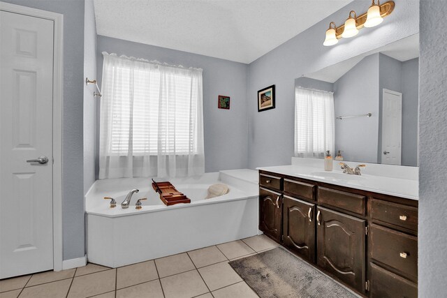 bathroom with tile patterned floors, vanity, and a healthy amount of sunlight