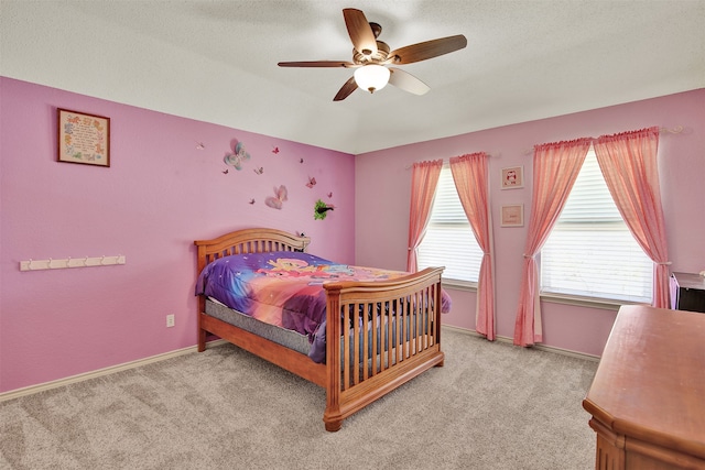 carpeted bedroom featuring a textured ceiling and ceiling fan