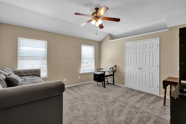 living area with a textured ceiling, light colored carpet, ceiling fan, and lofted ceiling