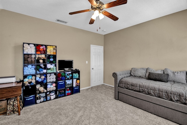 interior space featuring ceiling fan and a textured ceiling