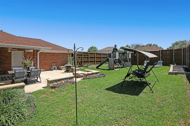 view of yard with a patio area and a playground