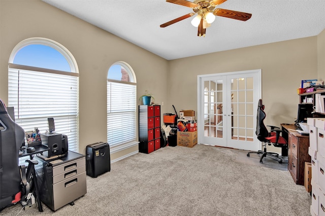 home office with light carpet, french doors, ceiling fan, and a textured ceiling