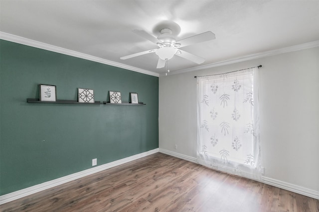 empty room with ornamental molding, hardwood / wood-style floors, and ceiling fan