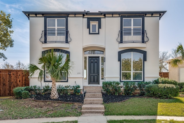 view of front of home featuring a balcony