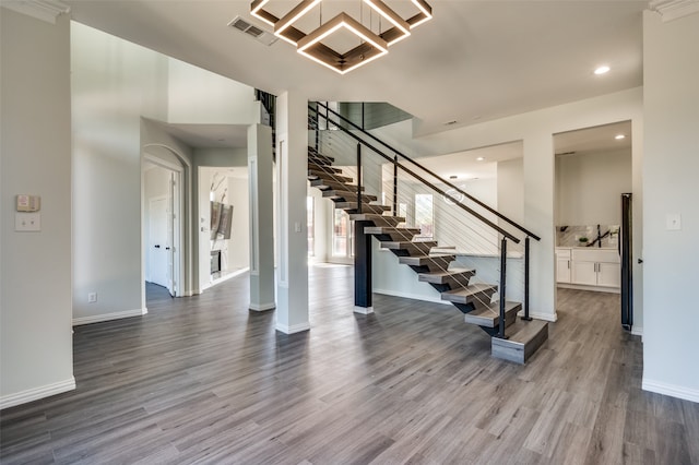 stairway with hardwood / wood-style flooring and sink