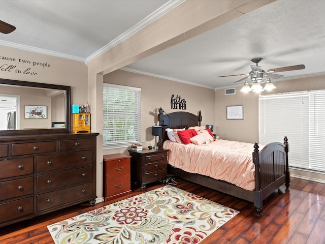 bedroom featuring crown molding, ceiling fan, and dark wood-type flooring