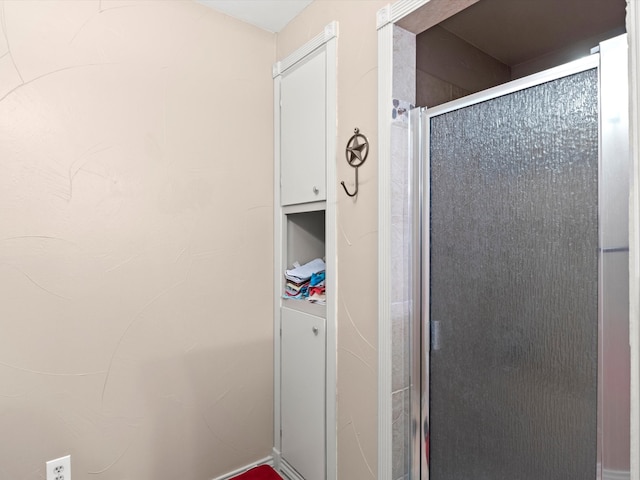 bathroom featuring a shower with shower door