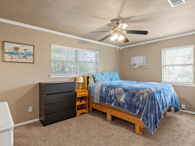 bedroom featuring ceiling fan, carpet floors, a textured ceiling, and multiple windows