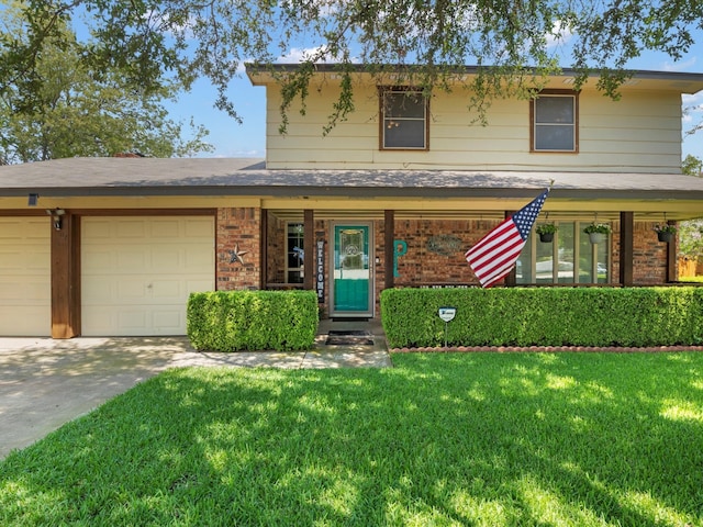 view of front facade with a front yard and a garage