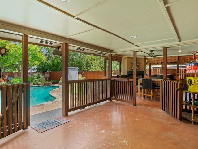 exterior space featuring a fenced in pool and ceiling fan