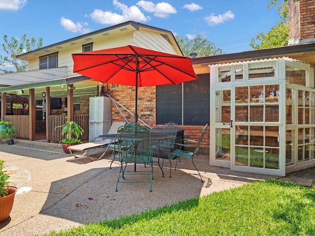 view of patio featuring a sunroom