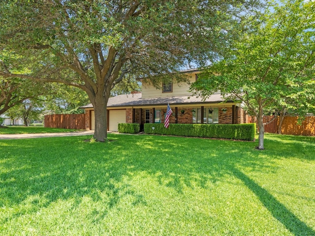 view of front of house with a garage and a front lawn