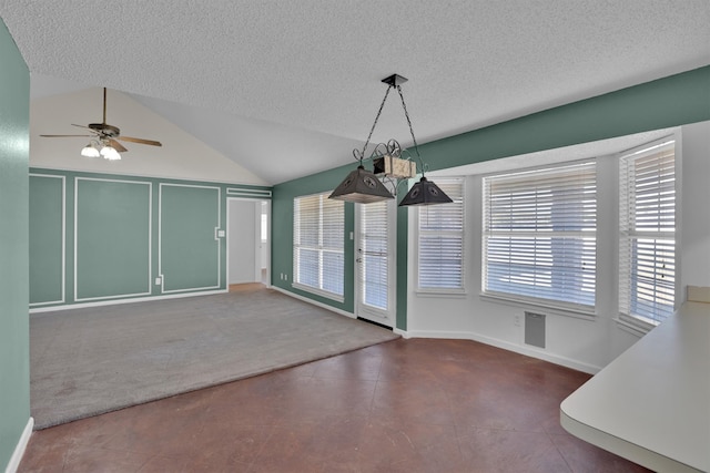 unfurnished dining area featuring a textured ceiling, ceiling fan, lofted ceiling, and carpet floors