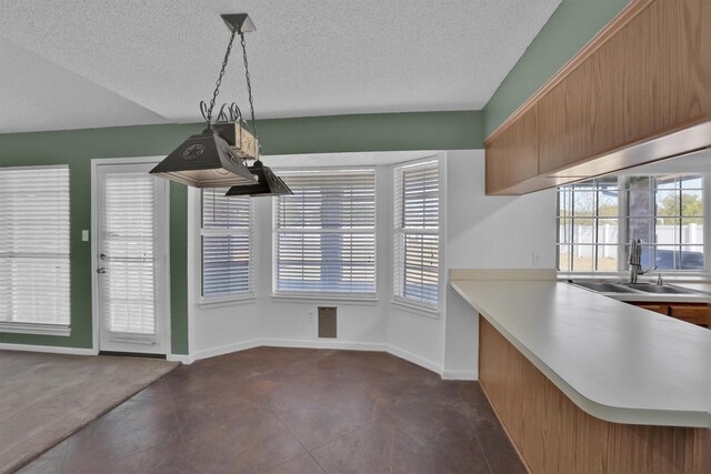 unfurnished dining area with sink and a textured ceiling