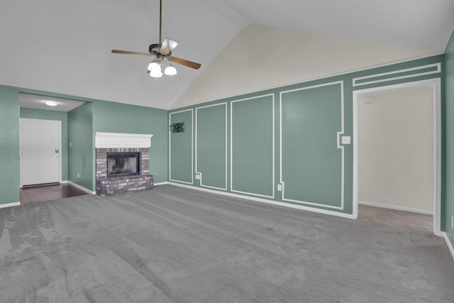 unfurnished living room with carpet flooring, ceiling fan, high vaulted ceiling, and a brick fireplace