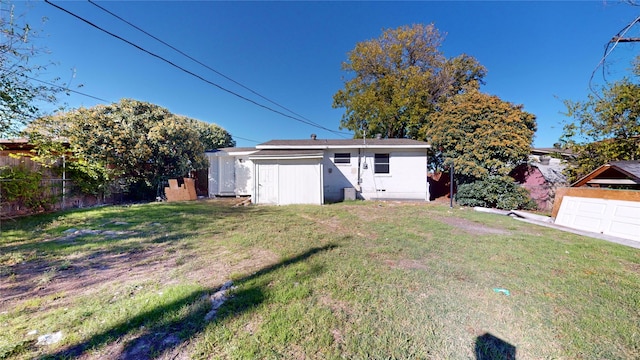 rear view of house featuring a yard