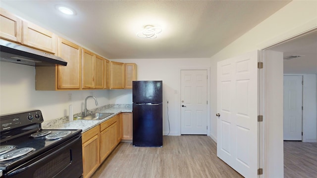 kitchen featuring light stone counters, sink, black appliances, and light hardwood / wood-style floors