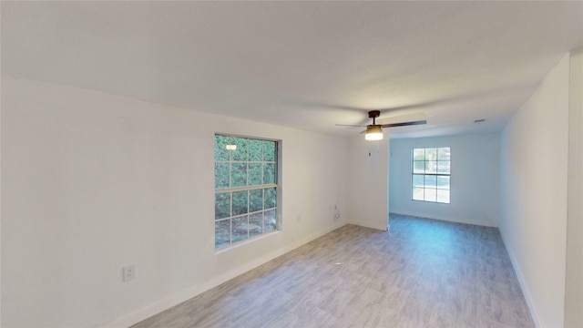 unfurnished room featuring ceiling fan and light wood-type flooring