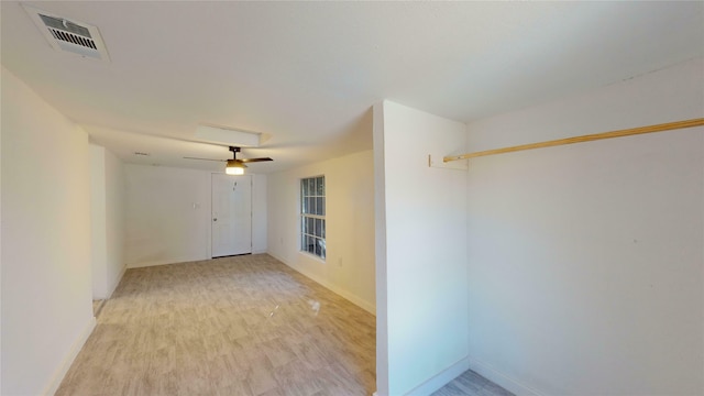 empty room with ceiling fan and light wood-type flooring