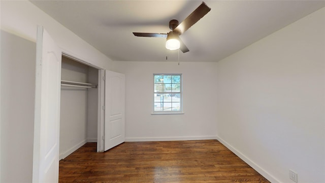 unfurnished bedroom featuring ceiling fan, dark hardwood / wood-style floors, and a closet