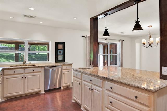 kitchen featuring pendant lighting, dark hardwood / wood-style floors, stainless steel dishwasher, and sink