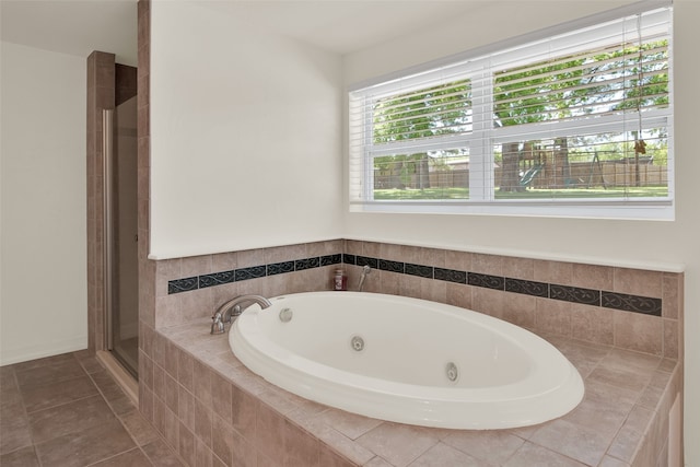 bathroom with tile patterned flooring and shower with separate bathtub