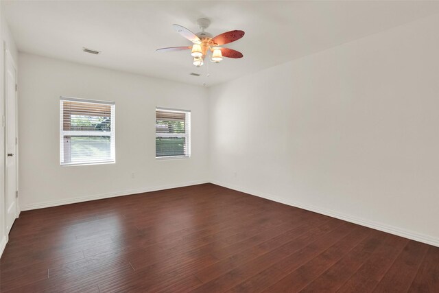 spare room featuring dark hardwood / wood-style floors and ceiling fan